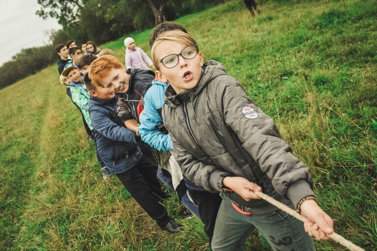 A group of kids playing tug of war.